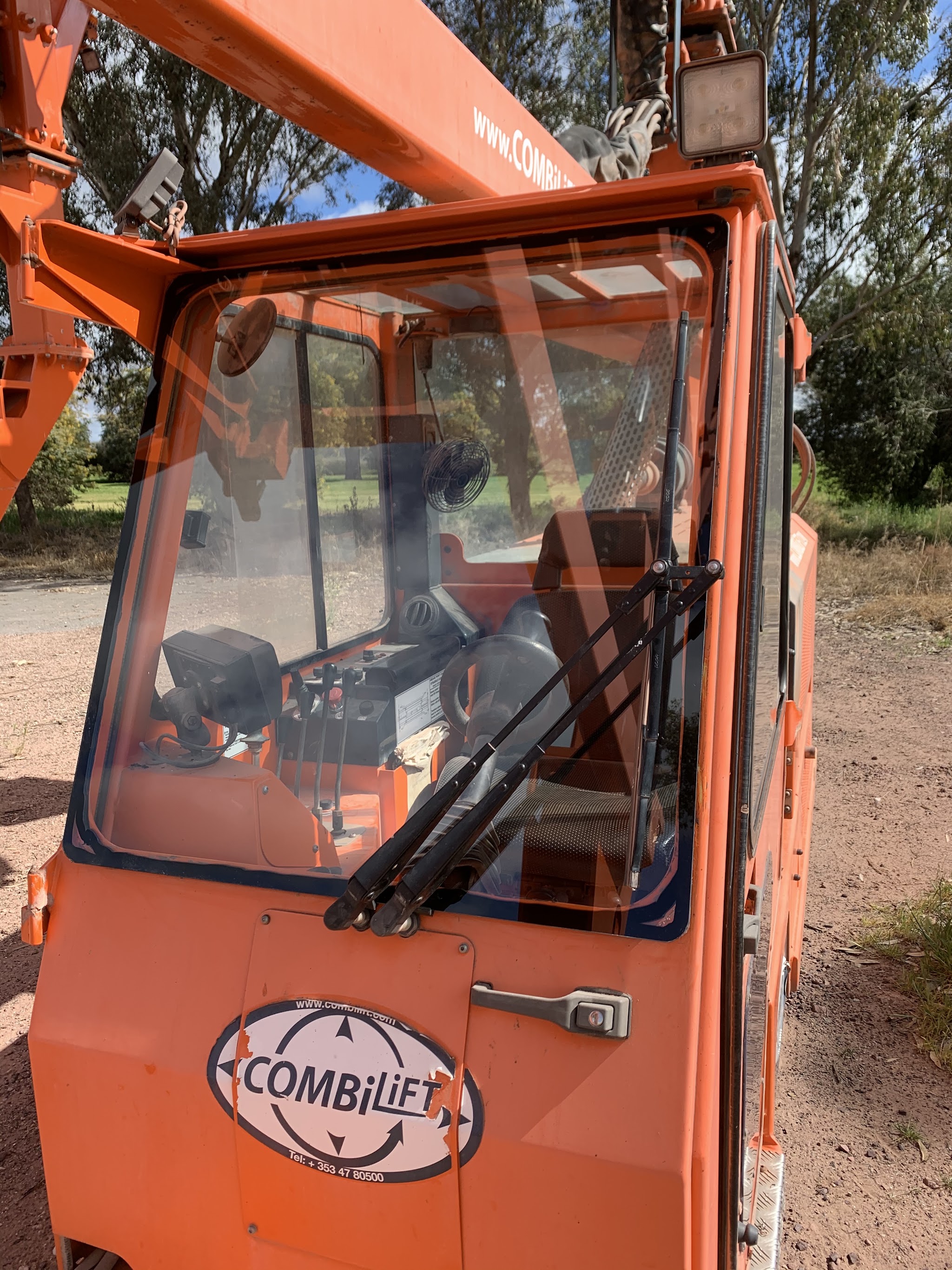 Freshly fitted cab glass in an orange Combilift machine, glazed on site