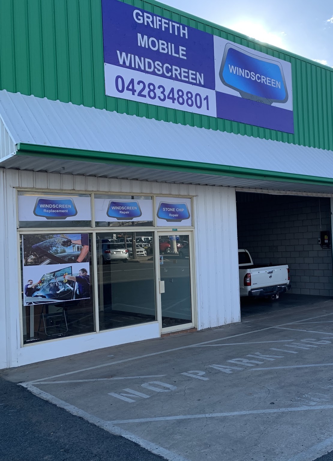 The Griffith Mobile Windscreens shopfront on Bonegilla Road, with the signwritten awning and the workshop roller door